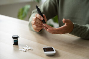 man measuring blood sugar level